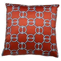 an orange and silver pillow with links on the front, sitting against a white background