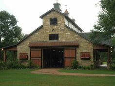 an old brick building with a clock tower on the front and side of it's roof