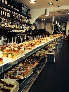 a long table filled with lots of food on top of plates next to each other