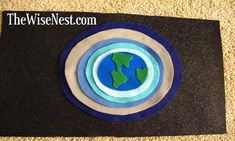 a black and blue place mat with the earth in it's center on carpet