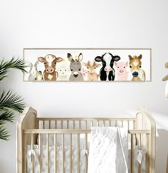 a baby's room with a white crib and several farm animals on the wall