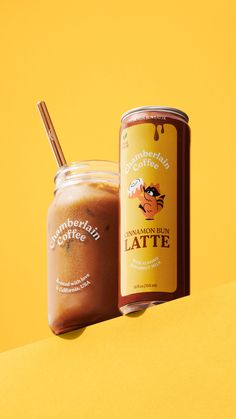 a jar of coffee sitting next to a canister on top of a yellow surface