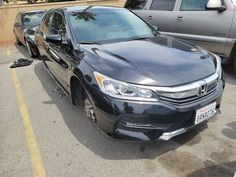 a black honda accord is parked in a parking lot