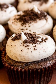 cupcakes with white frosting and chocolate sprinkles