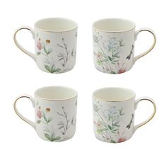 four coffee mugs with floral designs on the sides and gold rimmed handles, set of 4