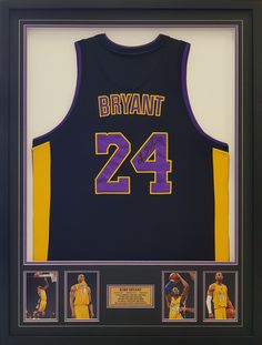 an autographed basketball jersey is displayed in a black frame with purple and yellow trim