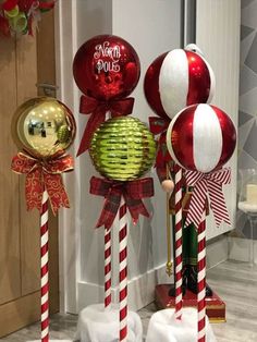 some christmas decorations are on display in front of a door with red and white stripes