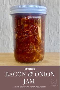 smoked bacon and onion jam in a jar with the words smoked bacon & onion jam written on it