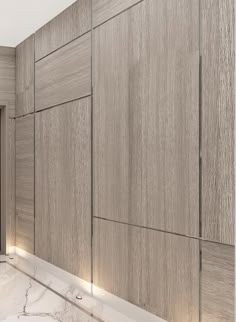 a bathroom with marble counter tops and wooden cabinets on the wall, along with a large mirror