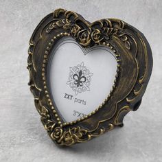 a heart shaped frame with an ornate design on the front and sides, is shown