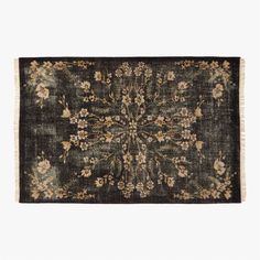 an antique rug with flowers and leaves on the side, in dark green tones against a white background