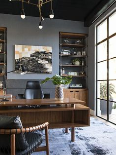 a desk with a plant in it and some bookshelves on the other side