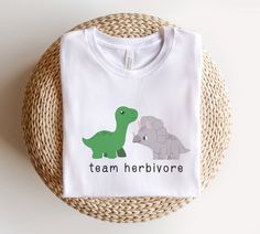 "team herbivore dinosaur vegan shirt, vegan fits, funny vegan shirt, vegetarian shirt, dinosaur shirt, gift for vegetarian, herbivore shirts FIT & COLOR -The Unisex t-shirts are relaxed and soft. If you want the shirt to have more of a fitted look, I would recommend to size down one size. - Please be sure to check out size chart before placing order. - Shirts are the soft Bella Canvas tees and are by far our favorite! - Black Shirts have white inscription and our White Shirts have black inscript Vegan Humor, Dinosaur Shirt, Vegan Clothing, Vegan Shirt, Vegan Gifts, Bella Canvas Tees, White Shirts, Social Media Post, Solid Black