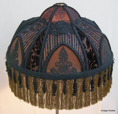 an ornate lamp shade with tassels and beads