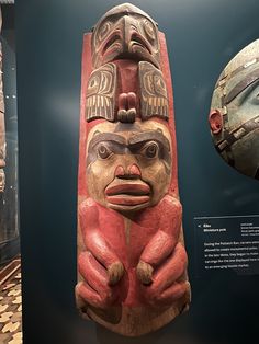 an old wooden statue is on display in a museum