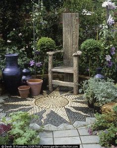 an outdoor garden with potted plants and a wooden chair in the center, surrounded by greenery