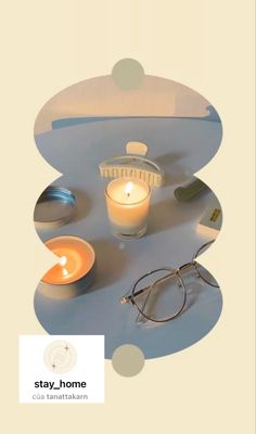 a candle, glasses and other items are arranged on a circular surface with circles around it