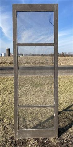 an open window sitting in the middle of a field