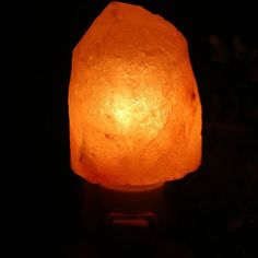 a large himalayan salt lamp lit up in the dark