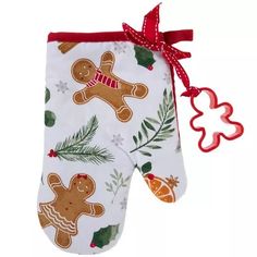 an oven mitt with gingerbreads and holly leaves on it, hanging from a red ribbon