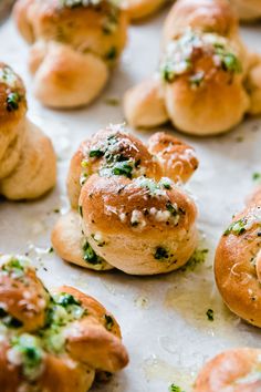 several rolls with cheese and herbs on them