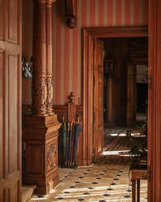 an ornately decorated hallway with striped walls and wood trimmings is seen in this image