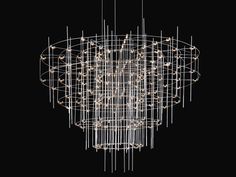 a large chandelier with lights hanging from it's sides and circular rods