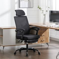 an office chair sitting in front of a computer desk