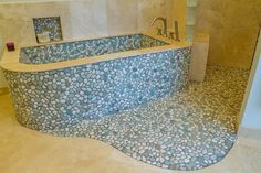 a bathroom with a stone bathtub and tile floor