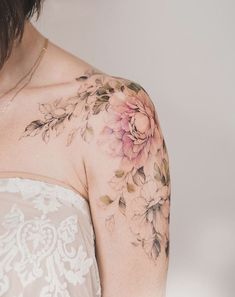 the back of a woman's shoulder with flowers on it