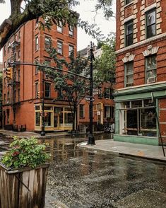 an empty city street with rain on the ground