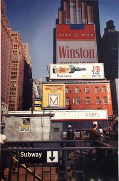 a tall building with many signs on it's side