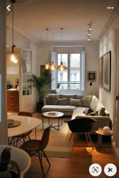 a living room filled with furniture and a flat screen tv mounted to the side of a wall