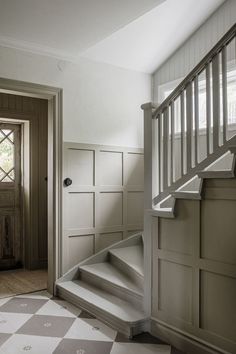 an empty room with stairs leading up to the door