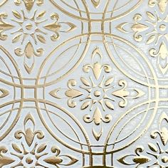 an intricately designed metal surface with gold accents