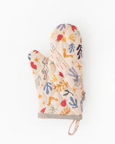 an oven mitt with colorful designs on the front and back, sitting on a white surface