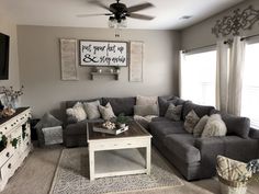 a living room filled with furniture and a flat screen tv mounted to the side of a wall