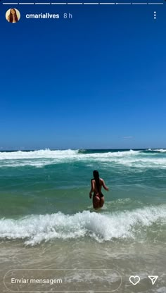 a woman is wading in the water at the beach