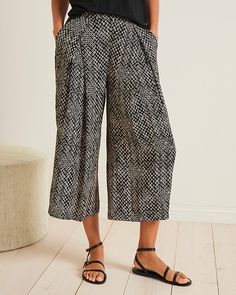 Palazzo-inspired pants, in sustainable viscose crêpe for crinkled texture and breezy ease. Detailed with a flat-front waist and dramatic front pleats that add unique interest to the stylish silhouette.  Exclusive. Elastic waist in back. Angled pockets. Wide leg.