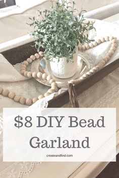 a tray with beads and a potted plant on it that says, $ 8 diy bead garland