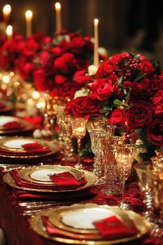 a long table is set with red roses and gold place settings for formal dinner guests