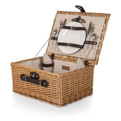 a wicker picnic basket with utensils and plates in the lid, on a white background