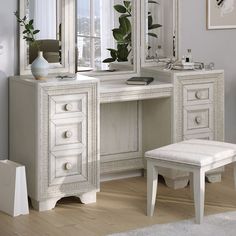 a white dressing table with mirror and stool