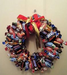 a wreath made out of candy bars is hanging on the wall