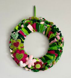 a wreath made out of green and pink fabric