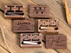 four wooden cufflinks with engraved names and initials on them, sitting on a table