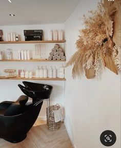 a hair salon with lots of products on the wall and shelves in front of it