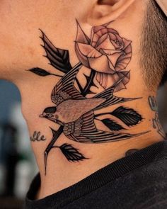 a man with a bird and rose tattoo on his neck