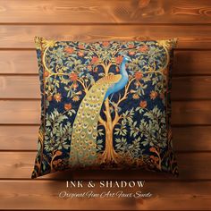 a decorative pillow with a peacock and tree design on the front, against a wooden wall