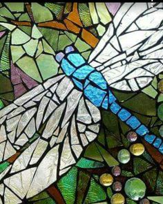 a stained glass window with a dragon on it's back and wings in different colors